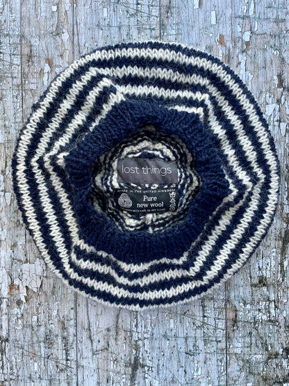 Navy Blue + White + Red Breton Stripes Wool Beret

Nautical style beret, beautifully hand knitted with Icelandic pure new wool, in Breton stripes of navy blue and white, with a big red pom and a navy blue ribbed band that gives the hat a snug fit. Perfect for keeping your head warm on cold days.

SIZE: adult.

DIAMETER: 11+1/2" / 29 cm.

CARE: hand wash or machine wash on wool cycle at 30 degrees, dry flat, do not tumble dry.