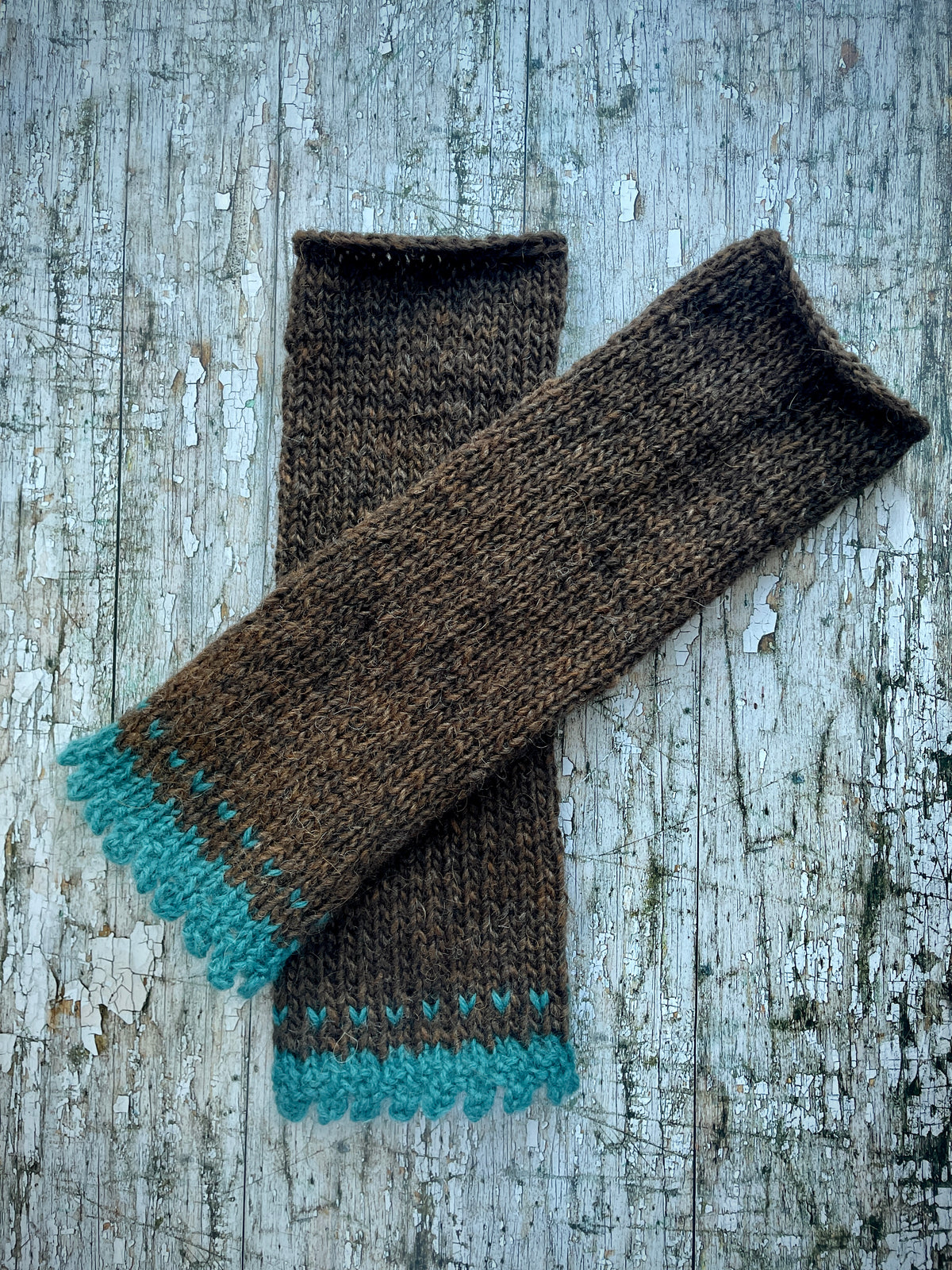 Hand Knitted Wool Fingerless Gloves

These long fingerless gloves have been beautifully hand knitted in dark chocolate Icelandic wool, with a soft, pretty edging of dark teal lambswool and kid mohair. Perfect for keeping your arms warm on cold days and adding a romantic touch to your outfit.

SIZE: adult.

LENGTH: 12+1/2" / 31cm.

CARE: hand wash, dry flat, do not tumble dry.