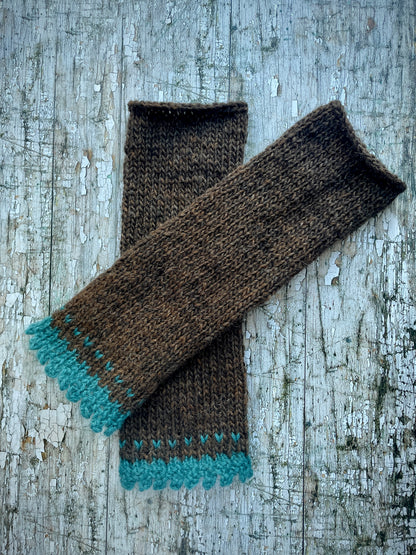Hand Knitted Wool Fingerless Gloves

These long fingerless gloves have been beautifully hand knitted in dark chocolate Icelandic wool, with a soft, pretty edging of dark teal lambswool and kid mohair. Perfect for keeping your arms warm on cold days and adding a romantic touch to your outfit.

SIZE: adult.

LENGTH: 12+1/2" / 31cm.

CARE: hand wash, dry flat, do not tumble dry.