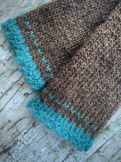 Hand Knitted Wool Fingerless Gloves

These long fingerless gloves have been beautifully hand knitted in dark chocolate Icelandic wool, with a soft, pretty edging of dark teal lambswool and kid mohair. Perfect for keeping your arms warm on cold days and adding a romantic touch to your outfit.

SIZE: adult.

LENGTH: 12+1/2" / 31cm.

CARE: hand wash, dry flat, do not tumble dry.