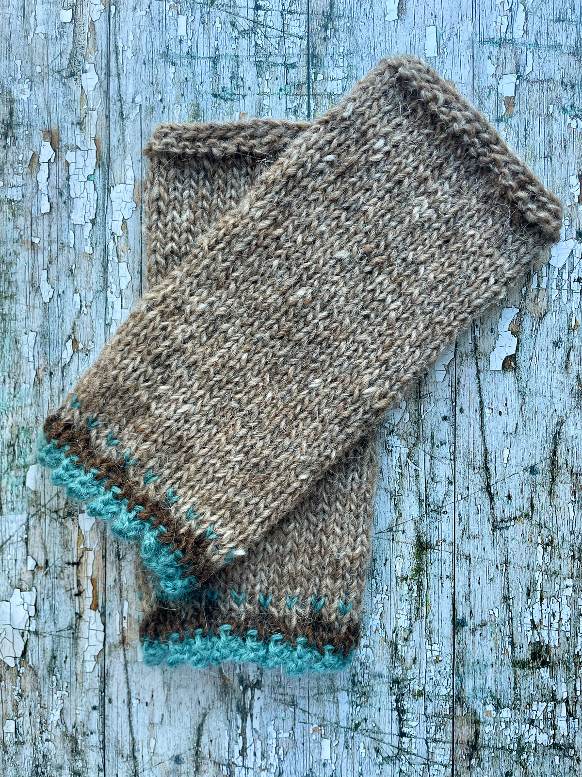 Hand Knitted Wool Wrist warmers

These wrist warmers have been beautifully hand knitted in dark oak and dark chocolate brown Icelandic wool, with a pretty, picot edging of soft pale teal lambswool and kid mohair to add a romantic touch to your outfit. Perfect for keeping your arms and hands warm on cold days while allowing your fingers to be free.

SIZE: adult.


LENGTH: 9+1/4" / 23.5cm.


WIDTH: 4+1/4" / 10.5cm.