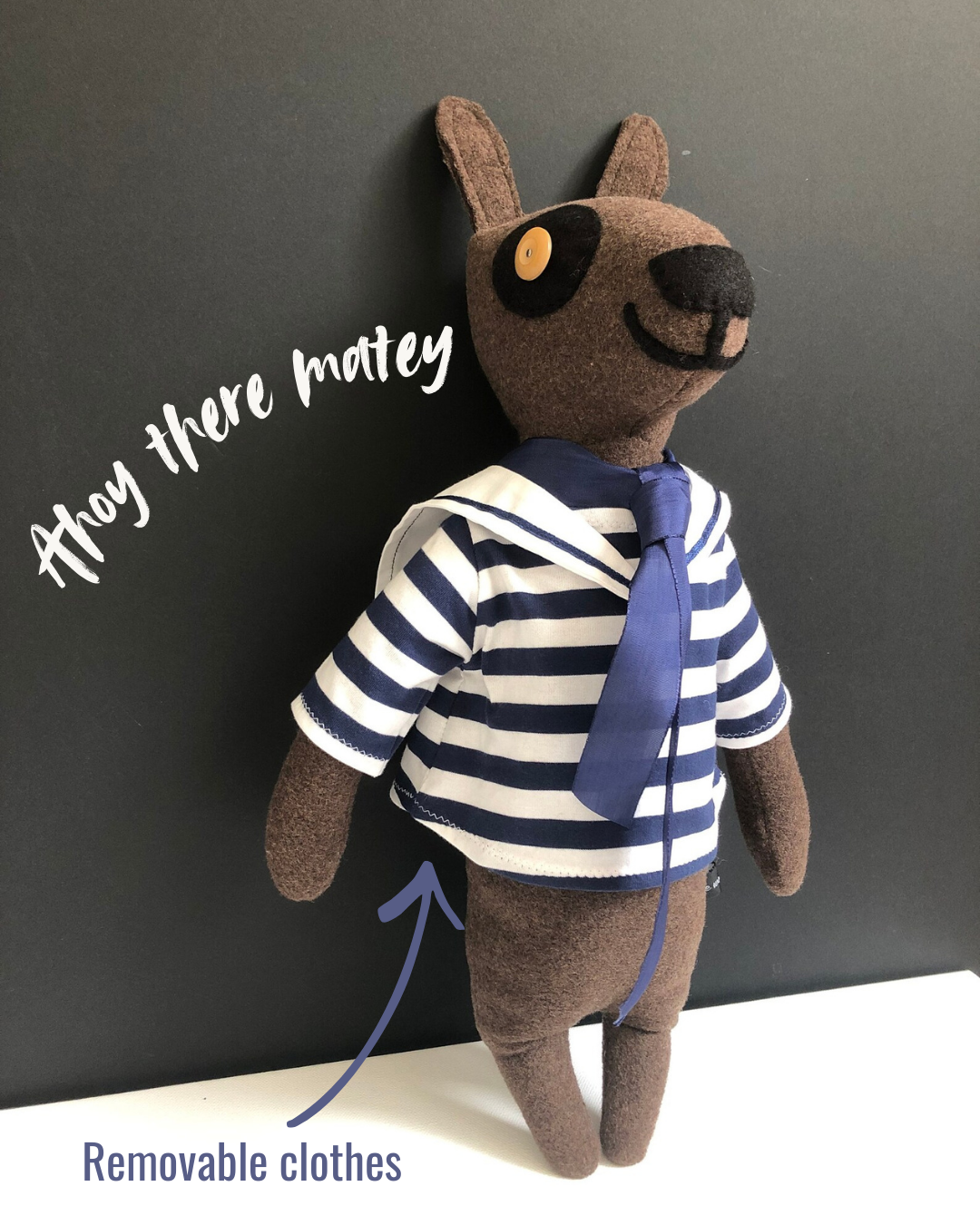 Sailor Sam Woolly Dog

Each woolly dog character I make is one of a kind with their own personality. Sam the sailor has been beautifully handmade with chocolate brown pure new wool and wears a removable blue and white stripe cotton sailor top with collar and blue tie.
Sam is filled with a non-allergenic soft toy filling conforming to BS + CE standards for hygiene + fire safety, which makes him firm and able to stand propped against a wall as a lovely nursery decoration.
NOT SUITABLE FOR CHILDREN UNDER 3