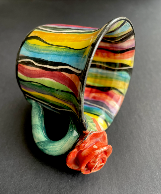 Vintage Mary Rose Young Signed Cup

Rare vintage handmade cup by the artist and potter who creates colourful one of a kind pieces in her studio in The Forest of Dean. Her work is very 'handmade' with colours roughly applied in different depths and white lines sometimes scored through the paint to the clay beneath. Her work is collectable and this is a rare signed piece dated 1990.