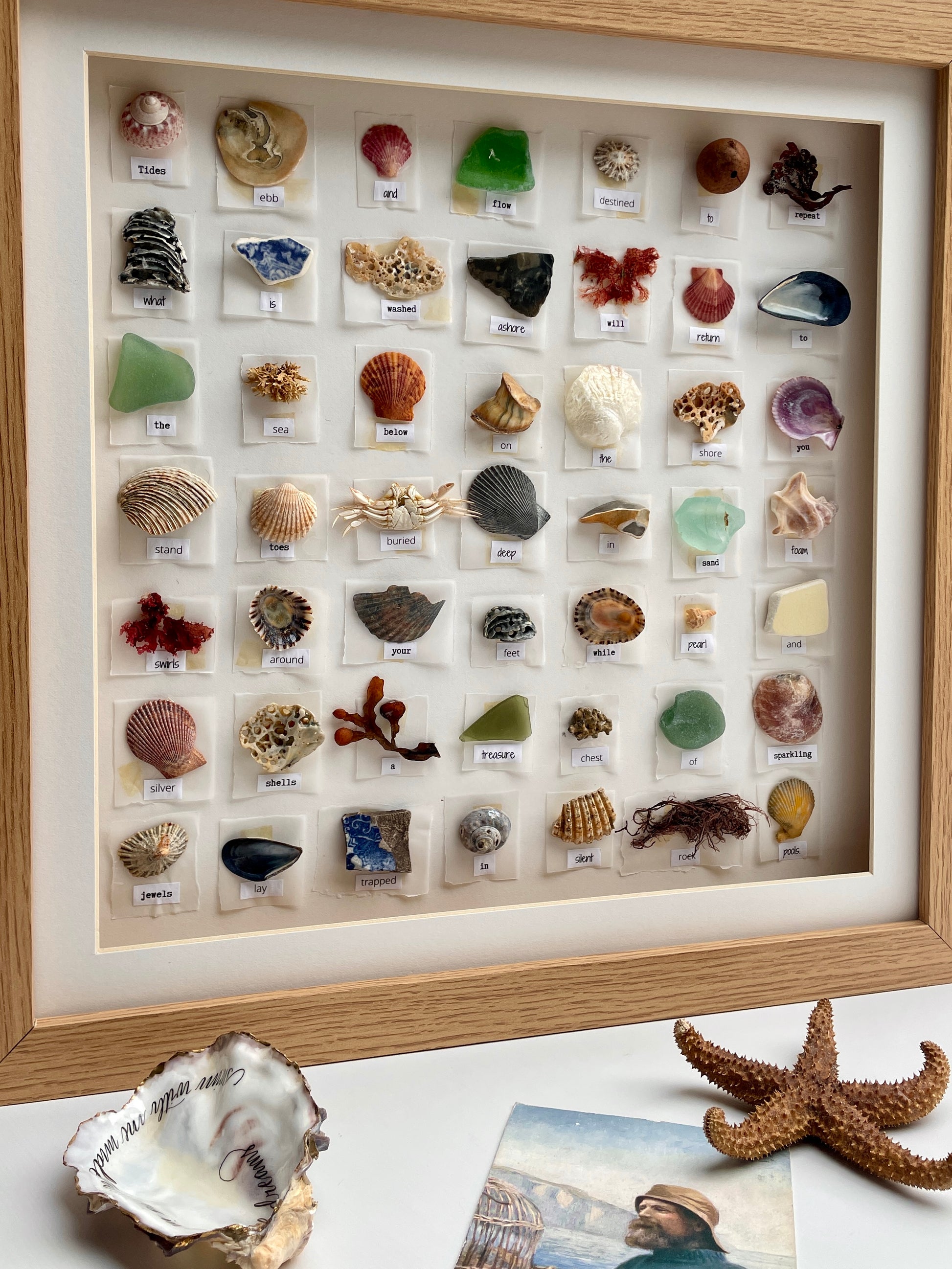 One Of A Kind Poetry Shell Art no.1
Items found on the Dorset beach by my home, each piece carefully chosen to give an interesting and varied selection of finds. Shells, seaweed, coral, seed pods, glass, pottery, crabs, pebbles, metal, barnacles or parts of crustaceans. Each find is attached to the cream background with a single word from a poem about the sea below it. The art work has a cream mount and sits inside a light oak coloured, 3D box with perspex.
Size of frame: 39.5 cm / 15" square.