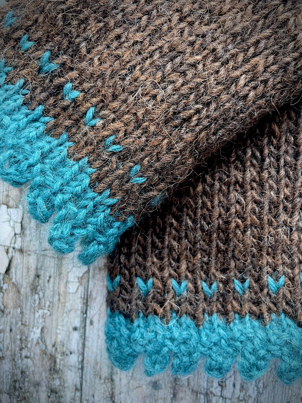 Hand Knitted Wool Fingerless Gloves

These long fingerless gloves have been beautifully hand knitted in dark chocolate Icelandic wool, with a soft, pretty edging of dark teal lambswool and kid mohair. Perfect for keeping your arms warm on cold days and adding a romantic touch to your outfit.

SIZE: adult.

LENGTH: 12+1/2" / 31cm.

CARE: hand wash, dry flat, do not tumble dry.