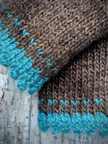Hand Knitted Wool Fingerless Gloves

These long fingerless gloves have been beautifully hand knitted in dark chocolate Icelandic wool, with a soft, pretty edging of dark teal lambswool and kid mohair. Perfect for keeping your arms warm on cold days and adding a romantic touch to your outfit.

SIZE: adult.

LENGTH: 12+1/2" / 31cm.

CARE: hand wash, dry flat, do not tumble dry.